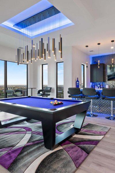 Modern Luxury Hill Top billiards room blue lighting contemporary bar statement chandelier Zbranek and Holt Custom Homes