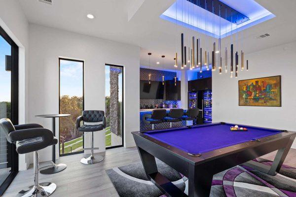 Modern Luxury Hill Top game room with bar floor to ceiling windows contemporary lighting Zbranek and Holt Custom Homes