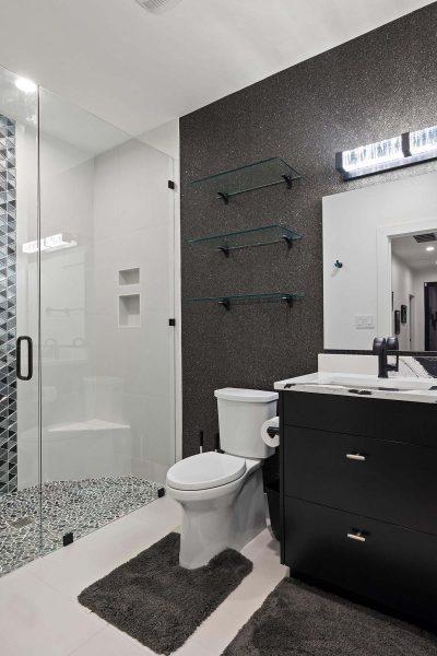 Modern Luxury Hill Top glass enclosed shower black vanity textured wall Zbranek and Holt Custom Homes