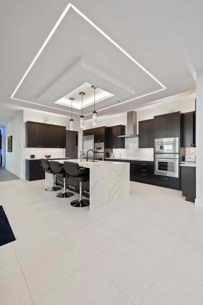 Modern Luxury Hill Top kitchen waterfall island crystal lighting dark cabinetry Zbranek and Holt Custom Homes