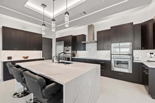 Modern Luxury Hill Top kitchen waterfall island quartz countertops crystal lighting Zbranek and Holt Custom Homes