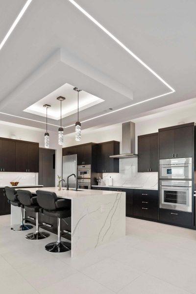 Modern Luxury Hill Top kitchen waterfall island recessed lighting dark cabinetry Zbranek and Holt Custom Homes