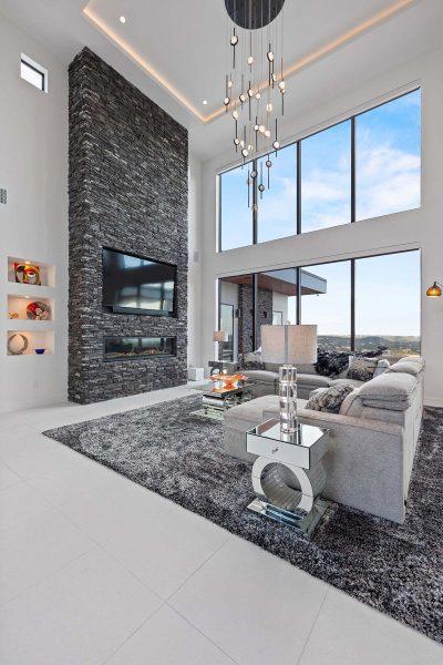 Modern Luxury Hill Top living room dramatic stone fireplace floor to ceiling windows Zbranek and Holt Custom Homes