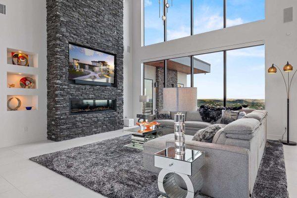 Modern Luxury Hill Top living room stacked stone windows mirrored decor Zbranek and Holt Custom Homes