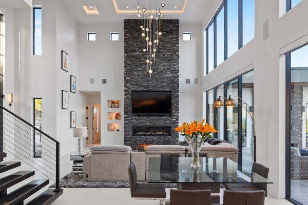 Modern Luxury Hill Top living room stone fireplace dining glass walls Zbranek and Holt Custom Homes