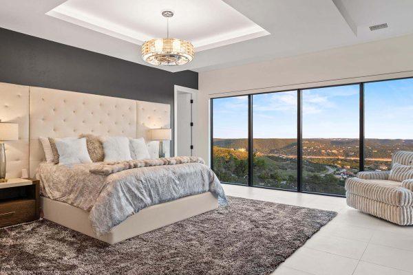 Modern Luxury Hill Top master bedroom tray ceiling lake view floor to ceiling windows Zbranek and Holt Custom Homes